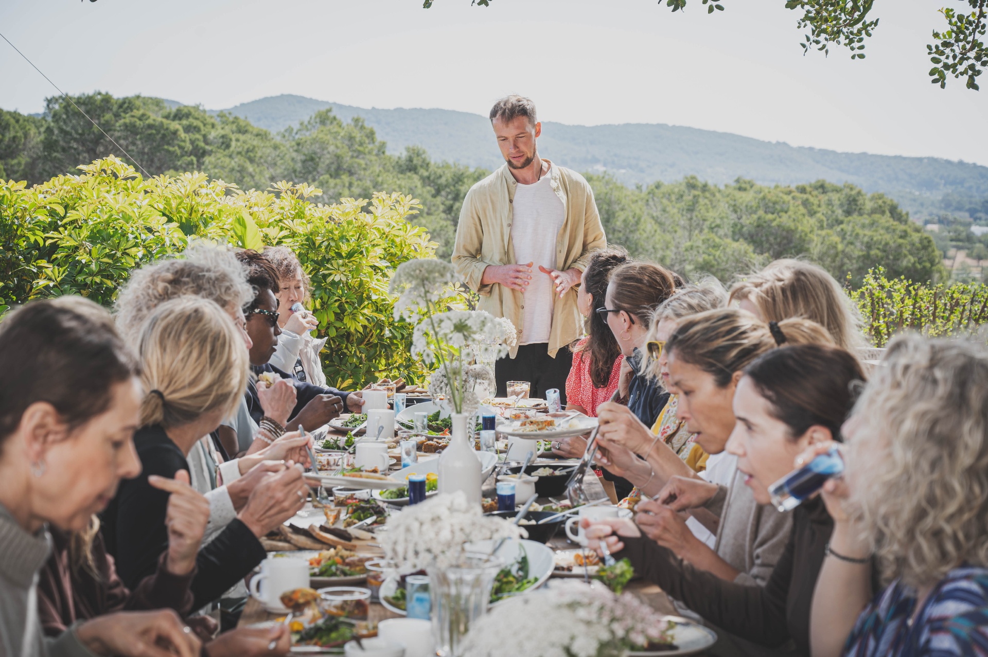 Long communal table shared meal outdoors